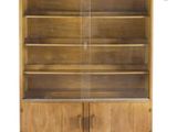 a close up of a wooden bookcase with glass doors