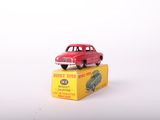 a red toy car sitting on top of a yellow box