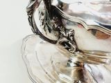 a silver plate with a horse on it on a table