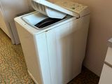 a washing machine in the corner of a kitchen