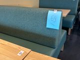 a table with a sign on it and a couch in the background