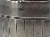 a silver cup that is sitting on a table