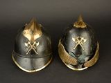 two helmets that are sitting side by side on a black surface