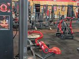 a gym with a lot of machines in the room