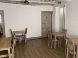 a dining room with wooden tables and chairs in it