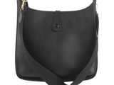 a black leather shoulder bag on a white background