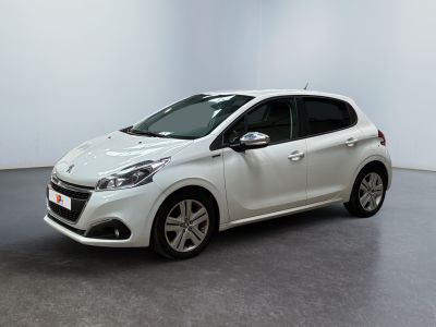 the white car is parked in a white room