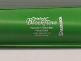 a close up of a green battery on a table