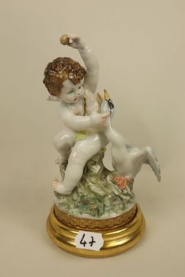 a figurine of a boy and a dog on a pedestal