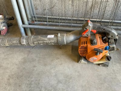 an image of a blower and a hose in a garage