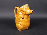 an image of a small yellow ceramic animal figurine on a black background