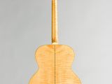 the back of an acoustic guitar with a wooden body