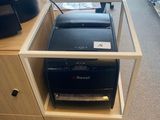 a printer sitting on top of a wooden desk