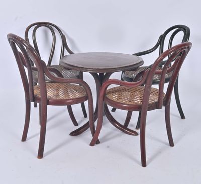 three chairs and a table in a room