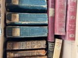 a box full of old books sitting on a table