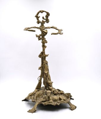 a gold plated candle holder with a bird on top of it