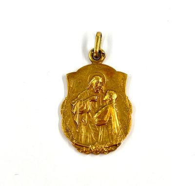an image of a gold medal with a picture of a woman holding a baby