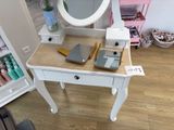 a white vanity with a mirror and a mirror on top of it