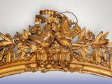 a gold frame with flowers and leaves on it