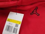 the back of a red sweatshirt with a tag on it