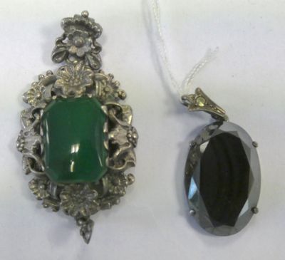 two pieces of jewelry that are sitting on a table