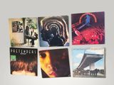 a lot of different album covers on the wall