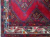 a close up of a rug with a red background
