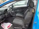 a blue car with black seats in a parking lot