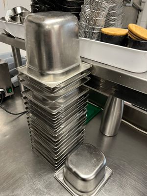 several pans stacked on top of each other in a kitchen