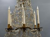 a chandelier that has five candles on each of it