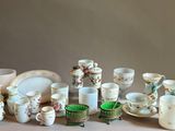 a lot of cups and saucers sitting on a table