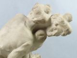 a statue of a man holding a child on his back