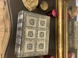 a picture of a table with a mirror and a book on it