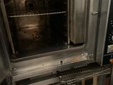 a silver oven that is open in a kitchen