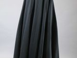 the back of a black cape is shown on a mannequin mannequin