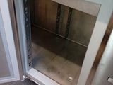 an open door to a stainless steel oven in a kitchen