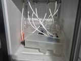 a small refrigerator with a bunch of wires in it