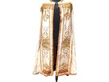 an image of a white and gold cape on a mannequin