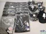 many bags of clothing and a hat on a table