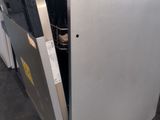 a refrigerator that has a door open in the kitchen