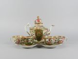 an image of a tea set with four cups and saucers