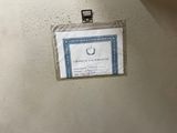 a picture of a badge on the wall of a bathroom