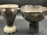 two vases sitting next to each other on a table