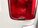 a close up of the tail light of a white truck