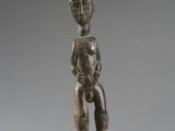 a small statue of a man with a hat on his head