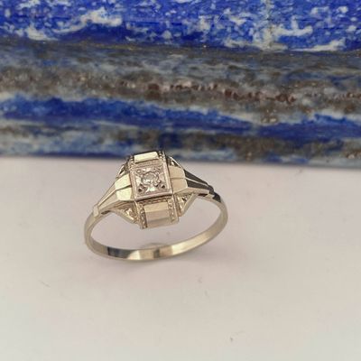 a gold ring with a diamond set in the center