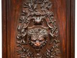 a wooden plaque with a lion ' s head in the center