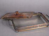 a silver tray with a lid on a gray surface