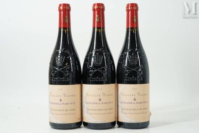 three bottles of red wine sitting on top of a white table