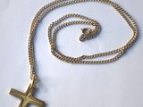 Collier avec chapelet et croix sur fond blanc, avec une chaîne dorée